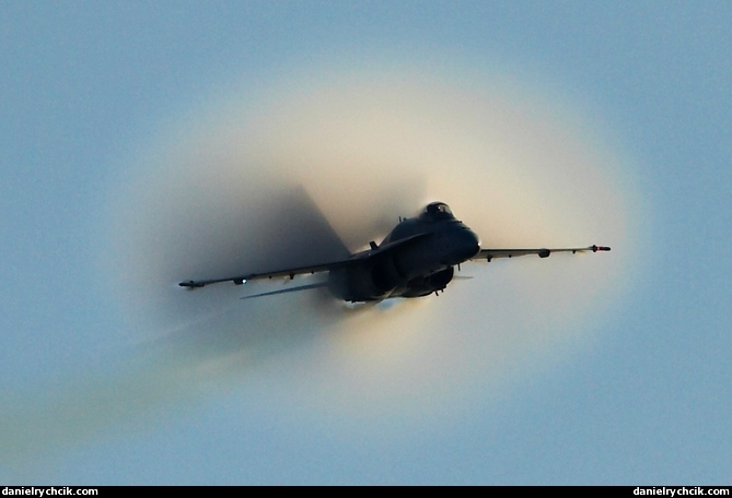 F-18 Hornet passing the condensation cloud