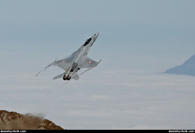 F/A-18C Hornet display climbing above the low clouds