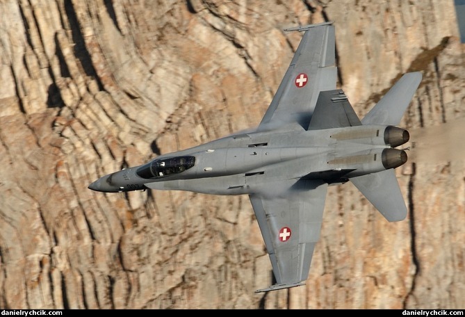 F/A-18C Hornet flying close to a mountain