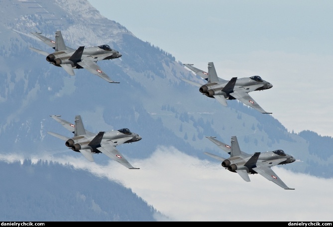 Four F/A-18C Hornets flying close formation above Axalp range