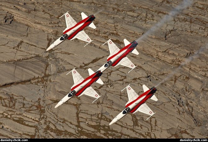 Four Tigers of Patrouille Suisse above the Axalp rocks