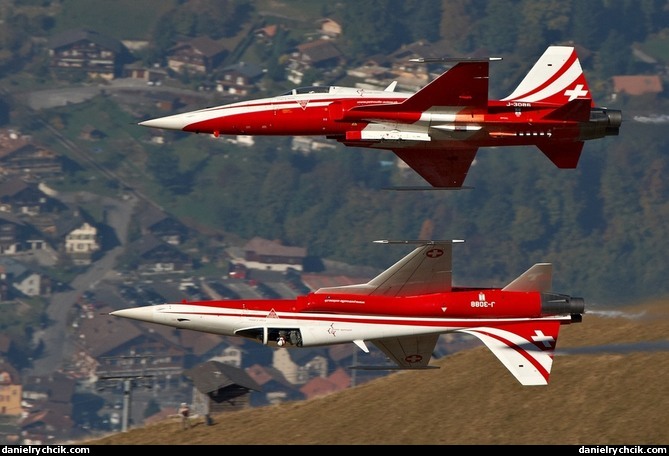 Mirror formation of Patrouille Suisse coming out of the valley