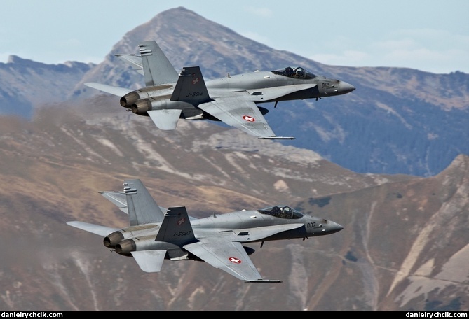 Two F/A-18C Hornets flying close formation above Axalp range
