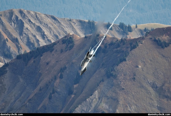 F/A-18C Hornet pulling down with a condensation cloud