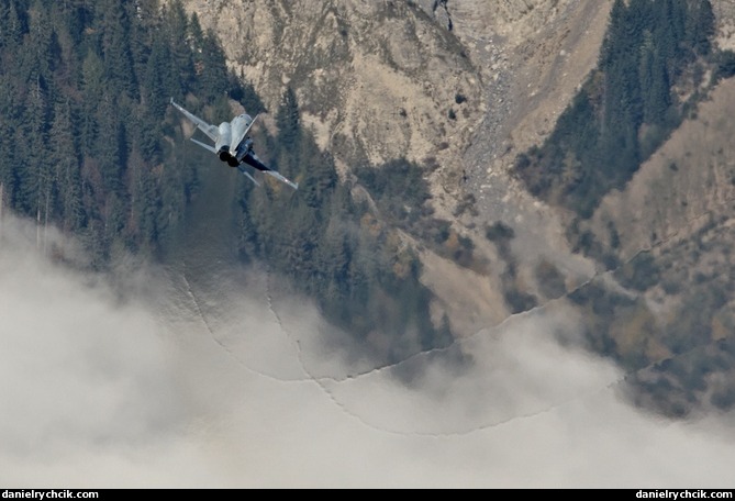 F-5E Tiger leaving vapour trail above the clouds